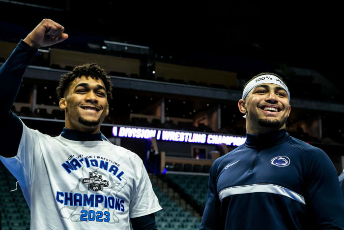 Penn State wrestlers Carter Starocci, left, and Aaron Brooks celebrate winning individual and team titles at the NCAA Wrestling Championships.